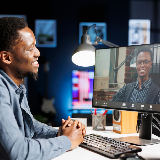 Recruiter interviewing another man on a video chat