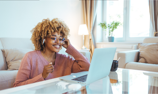 Black women in front of her computer on the phone