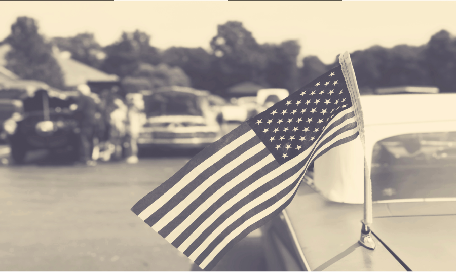 Black and white photo of an American flag on a street